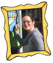 bookmobile artist, Leigh Schelman, signing the bookmobile at the kick-off celebration